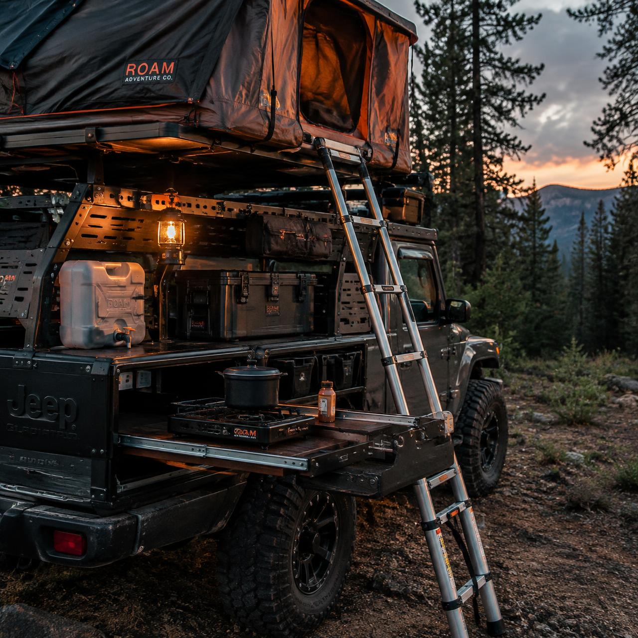 Outfitted truck bed with rooftop tent, camp kitchen and gear